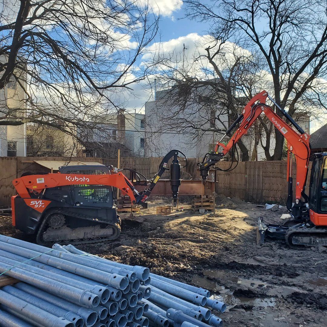 Galvanized pile shafts staged on site before installation